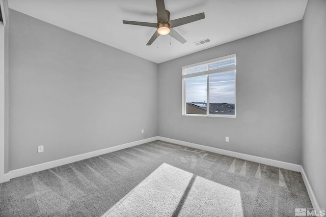 empty room with ceiling fan and carpet flooring