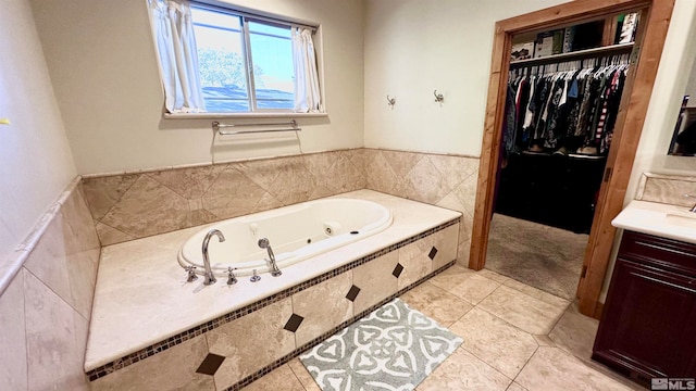 bathroom featuring vanity, tiled bath, and tile patterned floors