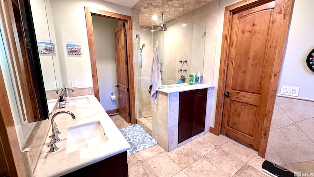 bathroom with vanity, tile patterned floors, and tiled shower