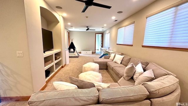 living room featuring ceiling fan and light colored carpet