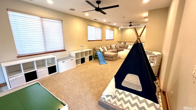 game room with carpet flooring and ceiling fan