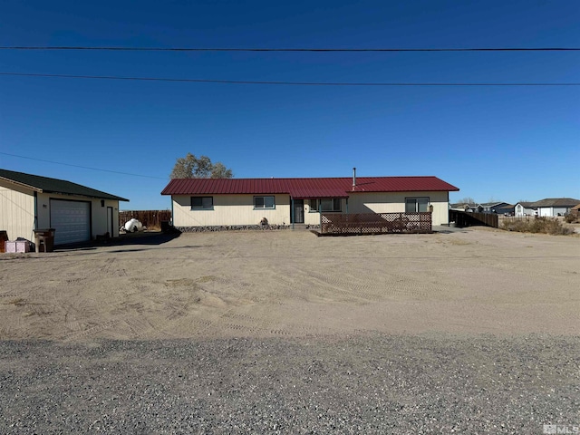 single story home featuring an outbuilding and a garage