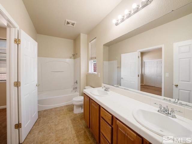 full bathroom with vanity, toilet, and bathtub / shower combination