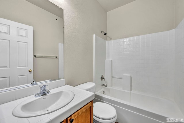 full bathroom featuring vanity, bathing tub / shower combination, and toilet