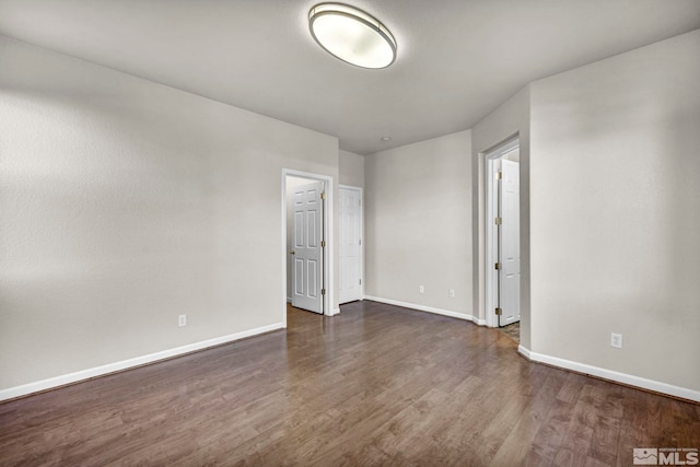 empty room featuring dark wood-type flooring