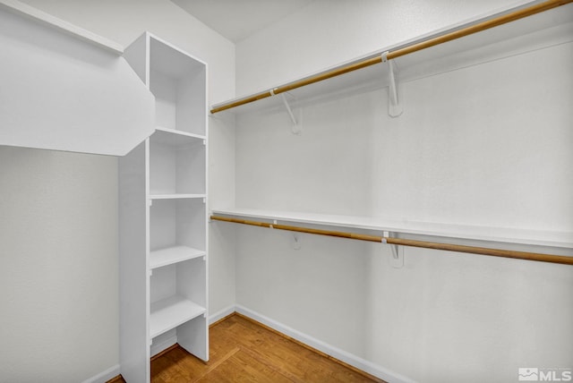 walk in closet featuring light hardwood / wood-style flooring