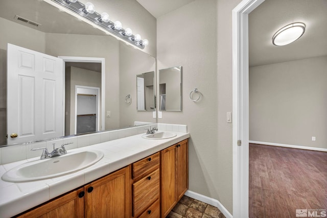 bathroom with vanity and wood-type flooring