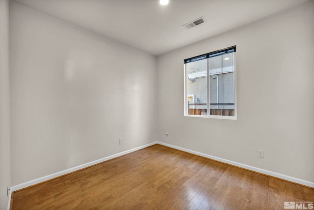 empty room featuring hardwood / wood-style flooring