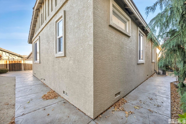 view of side of property featuring a patio