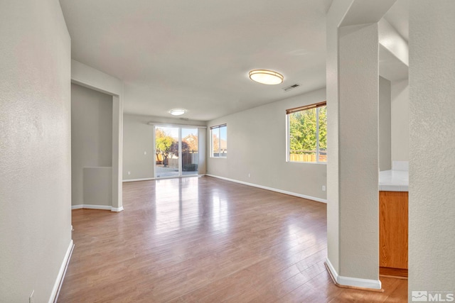 empty room with hardwood / wood-style flooring