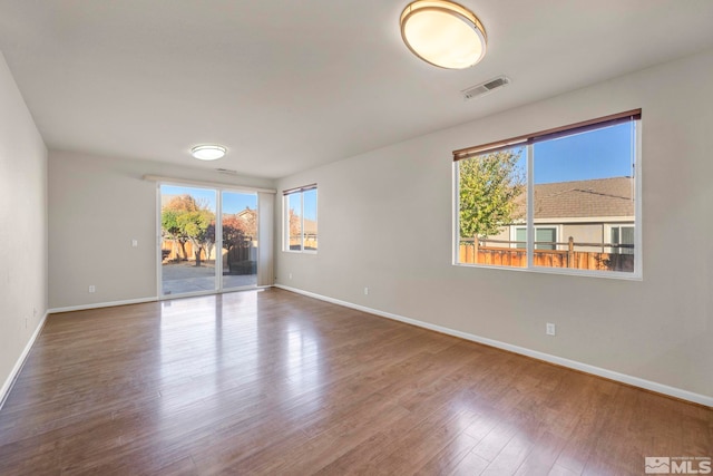 unfurnished room with hardwood / wood-style floors