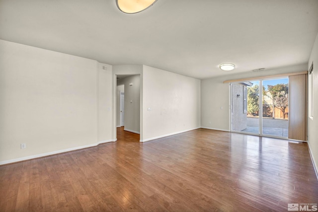 spare room featuring hardwood / wood-style floors