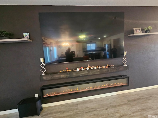 room details with wood-type flooring and stainless steel fridge