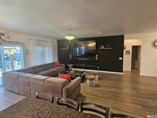 living room featuring hardwood / wood-style flooring and a textured ceiling