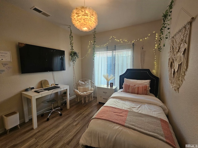 bedroom with dark hardwood / wood-style flooring