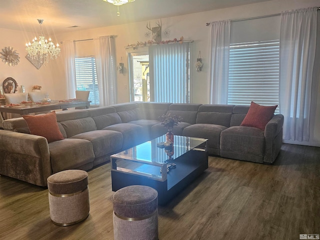 living room with a notable chandelier and hardwood / wood-style flooring