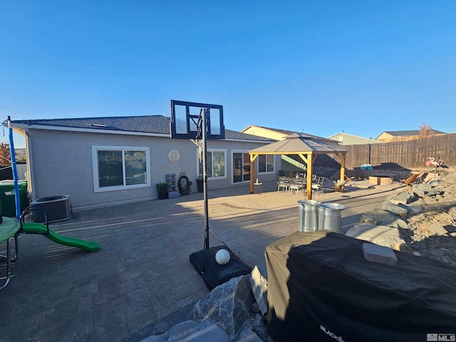 view of patio / terrace with area for grilling, central AC, and a gazebo