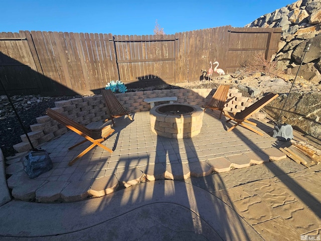 view of patio / terrace featuring an outdoor fire pit