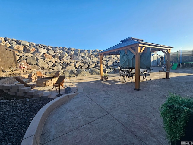 view of patio with a fire pit and a gazebo