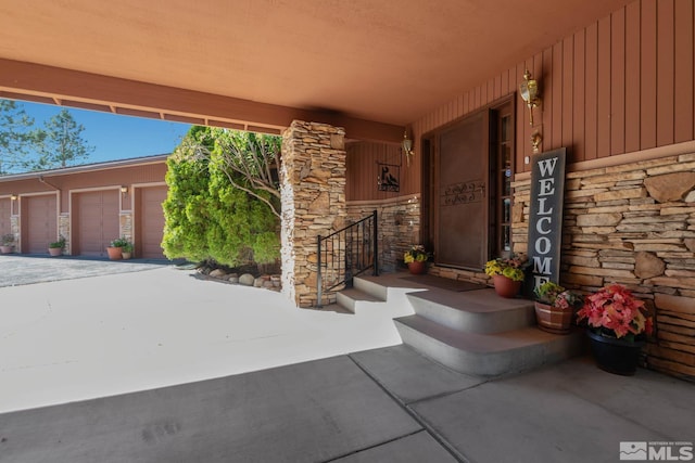 doorway to property with a garage