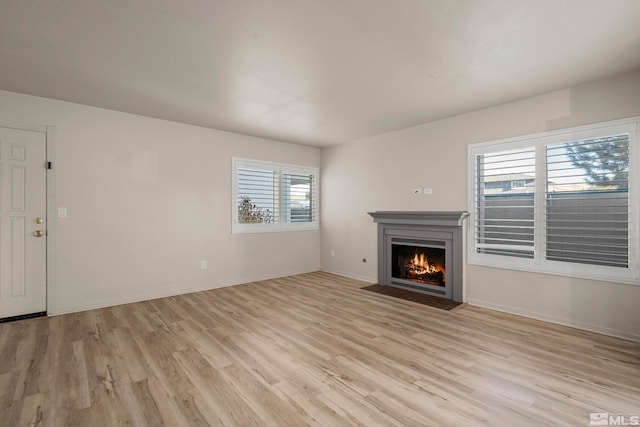 unfurnished living room with plenty of natural light and light wood-type flooring