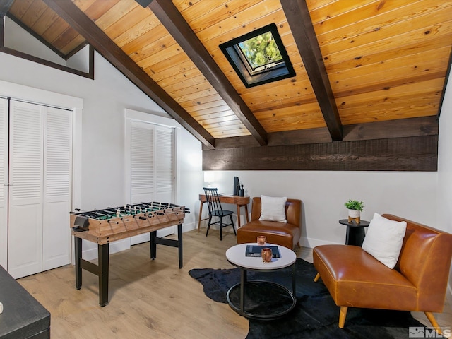 recreation room featuring wood ceiling, light wood-type flooring, and lofted ceiling with skylight