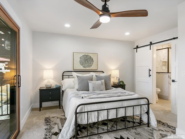 carpeted bedroom featuring a barn door, access to exterior, ceiling fan, and ensuite bathroom