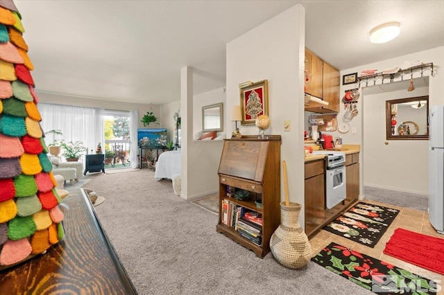 kitchen with white appliances and light colored carpet