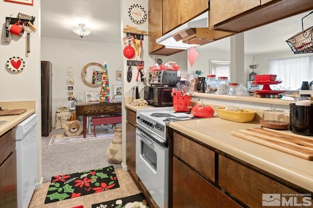 kitchen featuring white appliances and light tile patterned floors