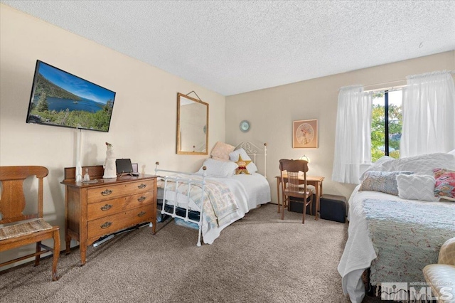 bedroom featuring carpet and a textured ceiling