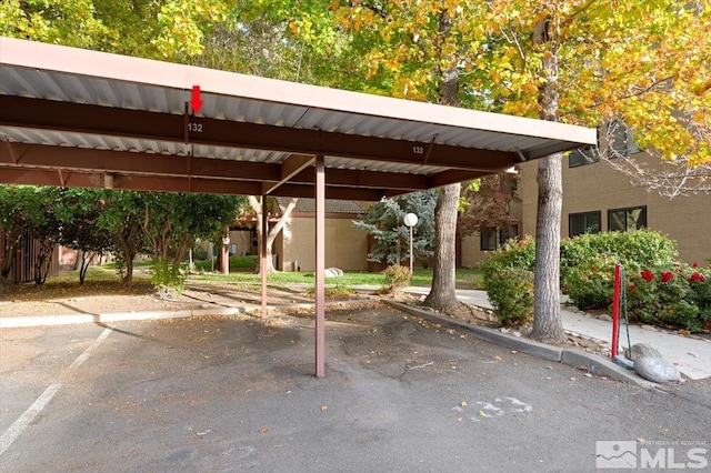 view of vehicle parking with a carport