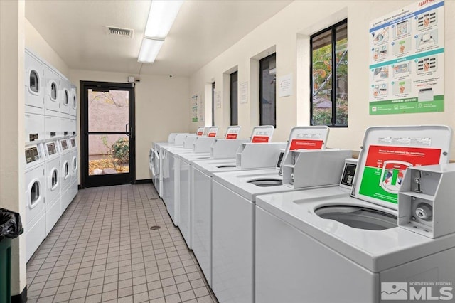 laundry room featuring washer and dryer and plenty of natural light