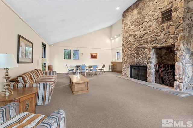 carpeted living room with a fireplace and high vaulted ceiling