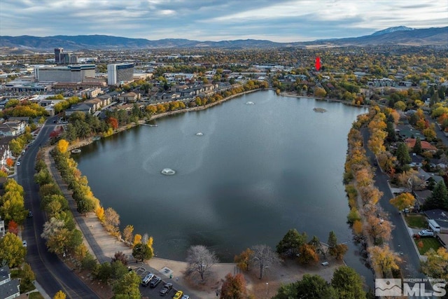 drone / aerial view with a water and mountain view