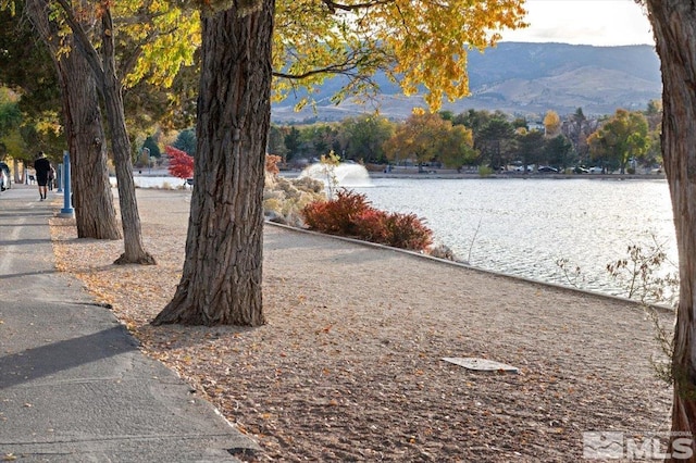 exterior space with a water and mountain view