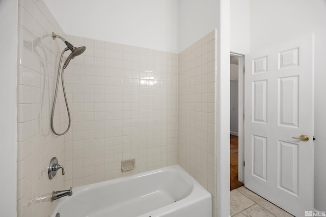 bathroom with tiled shower / bath combo and tile patterned floors