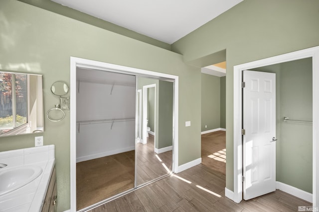 bathroom with vanity and hardwood / wood-style flooring