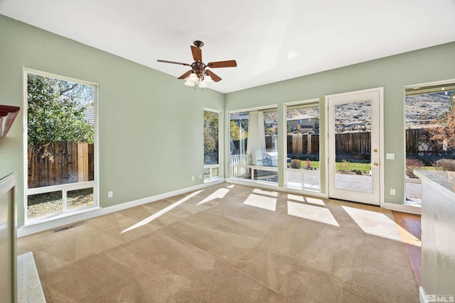 empty room with light colored carpet and ceiling fan