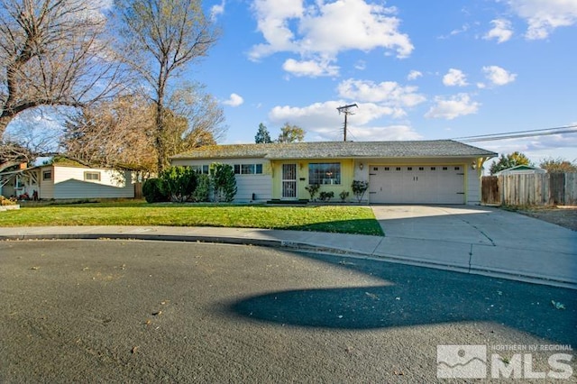 single story home featuring a garage and a front yard