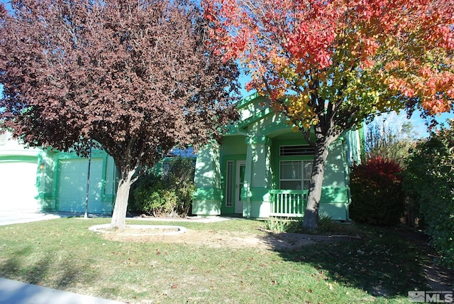 view of yard with a garage and covered porch