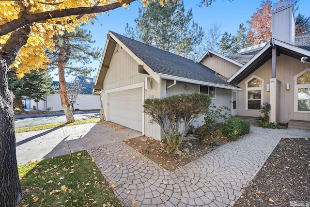 view of side of home featuring a garage