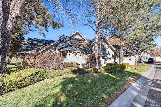 view of property featuring a front lawn