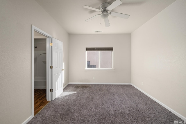 unfurnished bedroom with ceiling fan and dark colored carpet