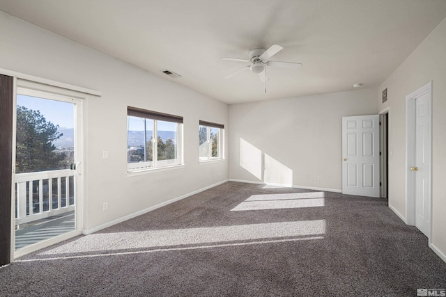 carpeted spare room with ceiling fan