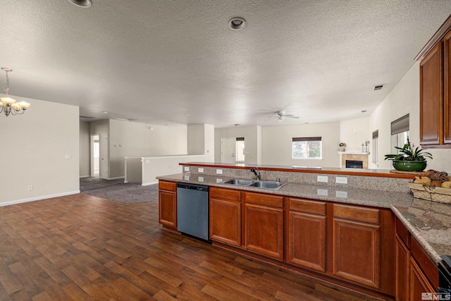 kitchen with dishwasher, a textured ceiling, dark wood-type flooring, and sink