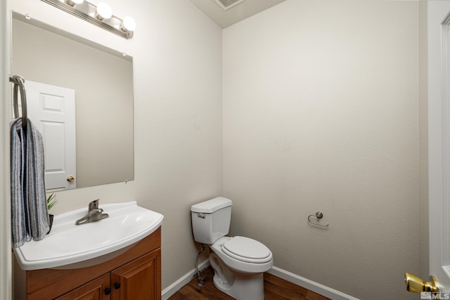 bathroom featuring hardwood / wood-style floors, vanity, and toilet