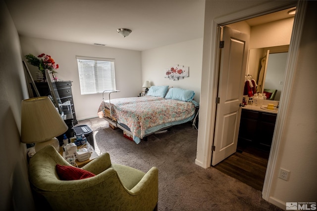 carpeted bedroom featuring connected bathroom