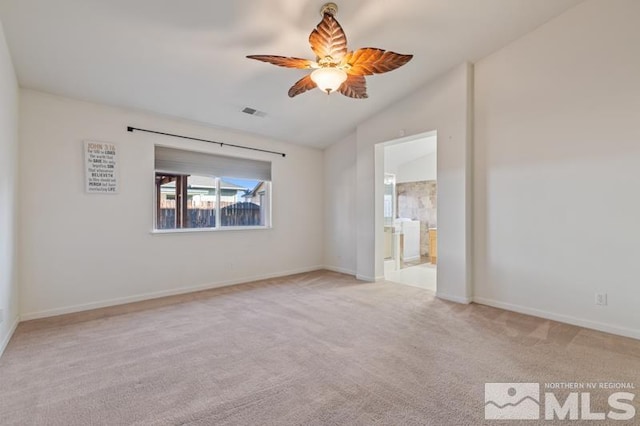 carpeted spare room featuring ceiling fan and vaulted ceiling