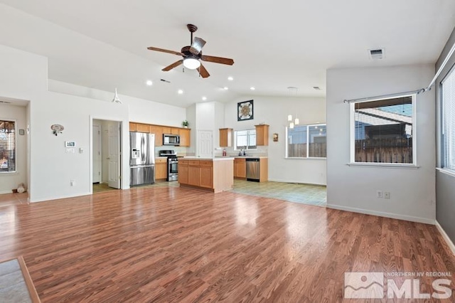 unfurnished living room featuring light hardwood / wood-style floors, ceiling fan, and lofted ceiling