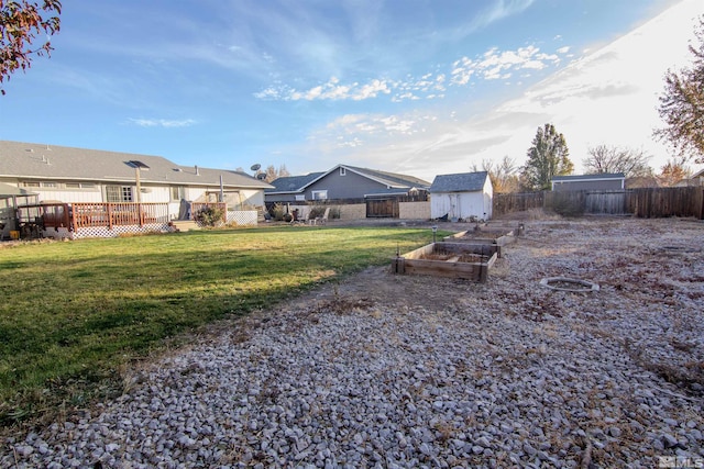 view of yard featuring a shed and a deck